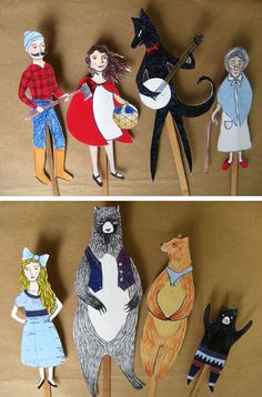 paper cutouts of people and animals on wooden sticks