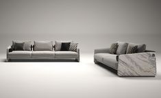 two couches and a chair in an empty room