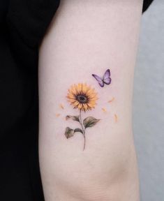 a sunflower and butterfly tattoo on the arm