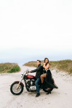 a man and woman are sitting on a motorcycle