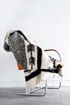 Queen sized ecru wool blanket with thin horizontal black stripes throughout the body and black arrow motif at both ends draped over a chair Black Blanket, Blanket Black, Handmade Blanket, Weighted Blanket, Hand Loom, Queen Size Bedding, Wool Blanket, Guatemala, Trunk