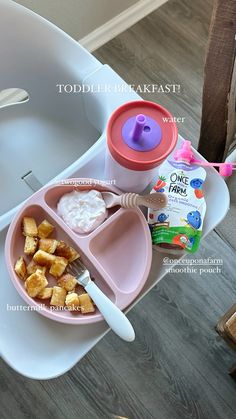 a child's lunch tray with cereal, milk and yogurt on it