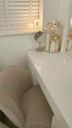 a chair sitting in front of a white counter top next to a mirror and bottles