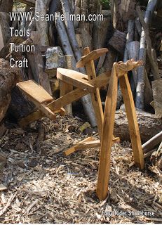 a wooden chair sitting on top of a pile of wood