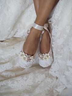 the bride's shoes are adorned with flowers