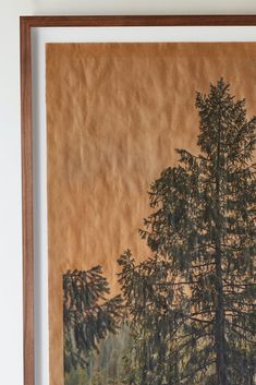 an image of a painting with trees in the background and brown paper on the wall