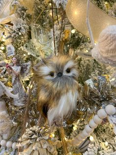 an owl ornament hanging from a christmas tree