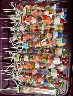 many candy lollipops are stacked on top of each other