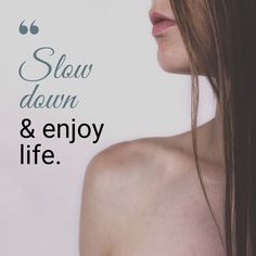 a woman with long hair standing in front of a white background that says slow down and enjoy life