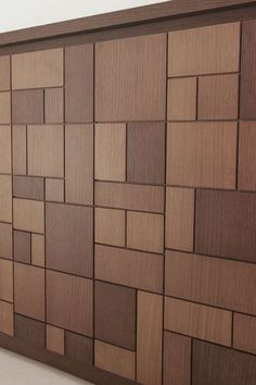 a wooden paneled wall with many squares on it