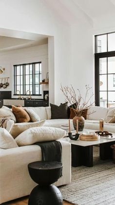 a living room filled with lots of white furniture