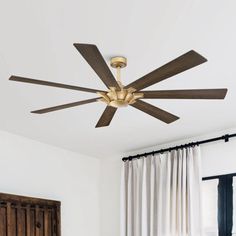 a ceiling fan in a bedroom with white walls