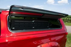 the back end of a red car with its trunk open