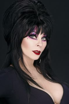 a woman with black hair and purple makeup