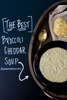 the best broccoli cheddar soup is served in a black bowl with a spoon