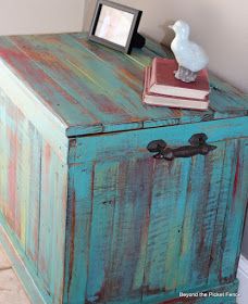 an old wooden box with some books on top