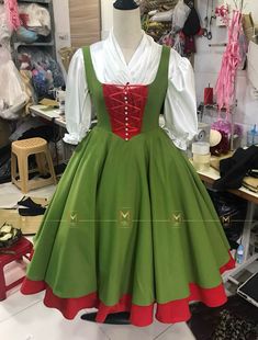 a green and red dress on display in a shop