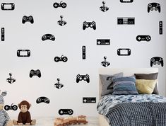 a child's bedroom with black and white decals on the wall, including video game controllers