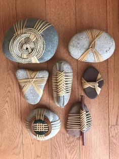 some rocks are sitting on the floor next to each other and tied together with rope