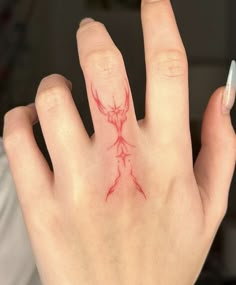 a woman's hand with red ink on it, showing the outline of a deer