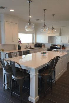 a large kitchen with an island in the middle