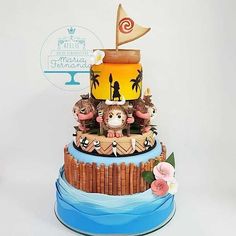 a three tiered cake decorated with figurines and decorations on top of it