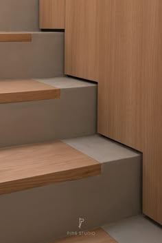 some wooden steps leading up and down to the top floor in a home or office