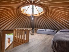 the inside of a yurt with two beds in it