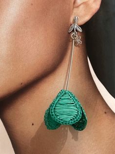 Intricately crafted, these Emerald Flower Shape Raffia Earrings are a delightful addition to any jewelry collection. The vibrant green color of the raffia material is eye-catching and unique, while the intricate flower shape design adds a touch of elegance. The lightweight nature of these earrings makes them comfortable to wear all day long, while still making a bold fashion statement. Perfect for adding a pop of color to any outfit, these earrings are versatile enough to be worn with casual or Green Bohemian Jewelry For Spring, Green Spring Beach Jewelry, Green Flower-shaped Pierced Earrings, Elegant Green Jewelry With Handmade Flowers, Green Flower Charm Drop Earrings, Elegant Woven Earrings For Spring, Green Dangle Jewelry For Spring, Green Drop Flower Earrings, Green Flower Shaped Earrings For Spring