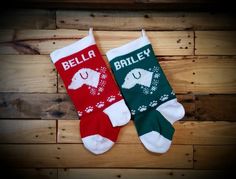 two personalized christmas stockings hanging on a wooden wall with the word bailey written in white and green