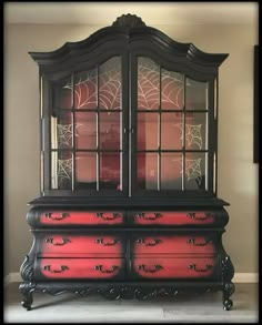 a black and red china cabinet with glass doors