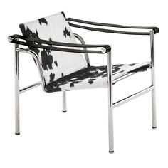 a black and white cow print chair with metal frame