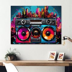 a wall hanging above a table with a boombox and speakers in front of it