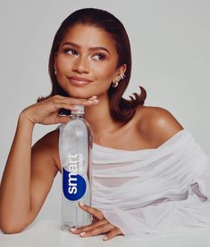 a woman posing with a water bottle in her hand