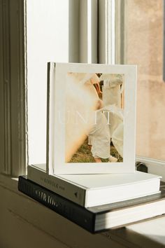 an open book sitting on top of a window sill