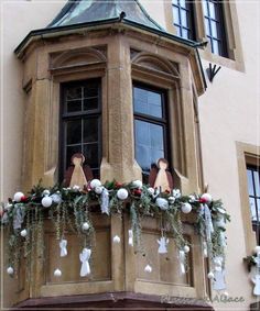 an ornate balcony decorated for christmas with ornaments