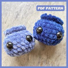 two blue crocheted teddy bears with black buttons