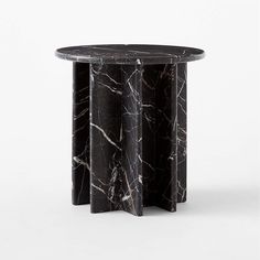 a black and white marble table with three sections on each side, one in the middle