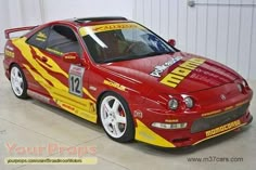 a red sports car with yellow flames painted on it