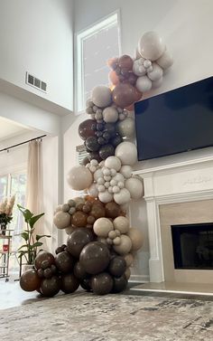 balloons are stacked on top of each other in front of a fireplace