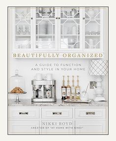 the book cover for beautifully organized is shown with white cabinets and silver appliances in it