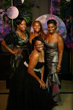 three women in evening dresses posing for the camera