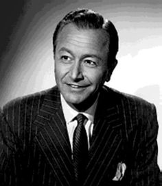 a black and white photo of a man in a suit with a smile on his face