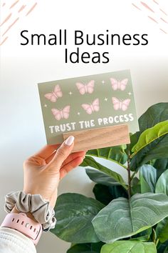 someone holding up a small business card with pink butterflies on it and the words, trust the process