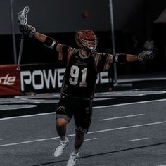 a lacrosse player with his arms in the air