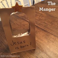 a paper bag with the word jesus is born written on it sitting on a wooden table