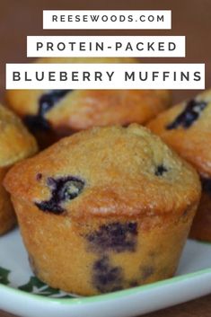 blueberry muffins on a green and white plate with text overlay that reads, protein - packed blueberry muffins