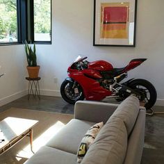 a red motorcycle is parked in the living room