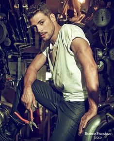 a man sitting on top of a motorcycle in a garage