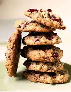 a stack of cookies with cranberries on top